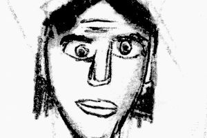 Rysunek narysowany węglęm, przedstawijący portret mężczyzny ze średniej długości włosami, duzymi oczami i ustami. Jakby narysowany ręką dziecka